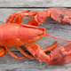 Raw lobster on wooden boardwalk